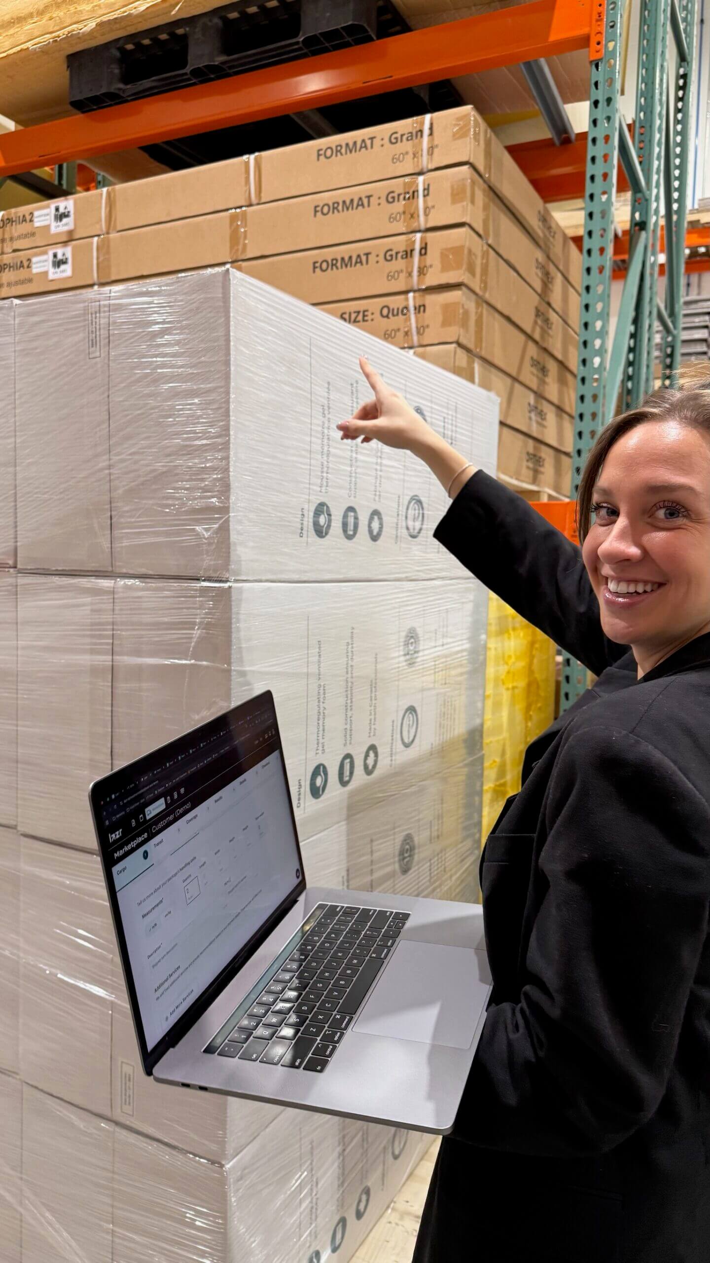 Warehouse shipper uses Lazr on a laptop to confirm an LTL freight quote, acting as her own broker next to palets.